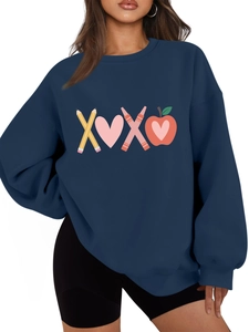 Close-up of navy sweatshirt featuring colorful XOXO prints with pencil and heart elements