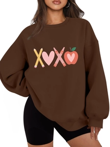 Detail of oversized dark brown sweatshirt featuring teacher-themed graphic and ribbed cuffs
