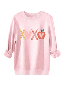 Detail of soft pink plush sweatshirt showing ribbed cuffs and creative XOXO graphic print