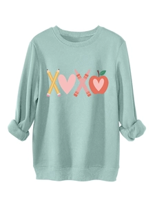 Detail of ribbed cuffs and creative XOXO graphic on mint green plush sweatshirt