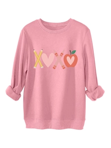 Close-up of pink crewneck sweatshirt featuring XOXO pencil and apple graphic print
