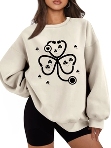 Detail of shamrock stethoscope print on warm drop shoulder sweatshirt in oatmeal beige