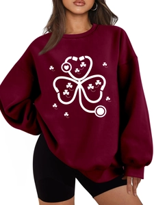 Detailed close-up of a maroon oversized sweatshirt with white stethoscope clover print