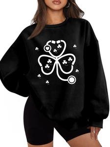 Detail shot of the white stethoscope and shamrock print on this black fleece sweatshirt