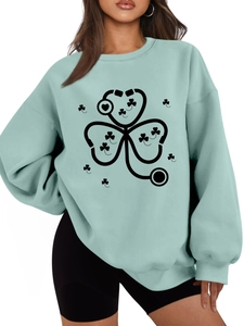 Detail of mint green sweatshirt featuring a stethoscope clover print and ribbed cuffs
