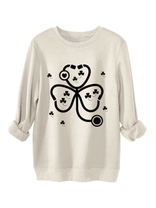 Close-up of stethoscope clover print on a beige thick warm sweatshirt fabric