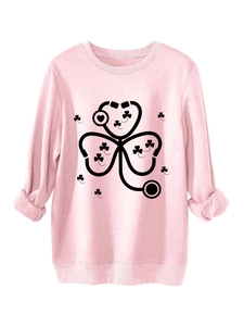 Detailed close-up of pink crewneck sweatshirt featuring stethoscope clover print design