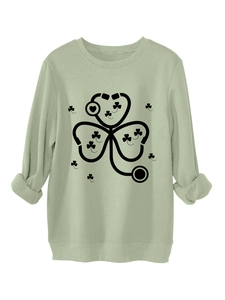 Detail of sage green sweatshirt featuring stethoscope clover print with ribbed cuffs and hem