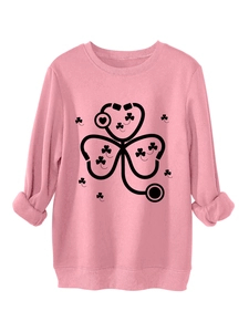 Detailed close-up of stethoscope shamrock print on pink warm crewneck sweatshirt