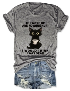 Flat lay of grey T-shirt with cat graphic paired with fringed blue denim shorts