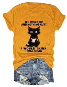 Detail of funny black cat and slogan print on mustard yellow crew neck cotton t-shirt