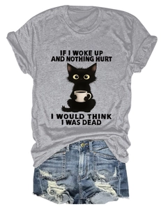 Detail of grey graphic T-shirt with cat print and distressed denim shorts ensemble