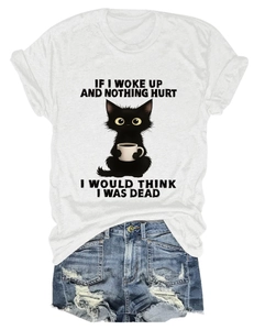 Close-up of white cotton T-shirt featuring funny cat and coffee print with distressed denim shorts