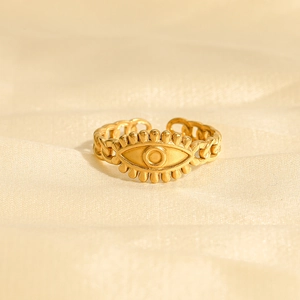 Golden Evil Eye open ring with Cuban link band on white satin background