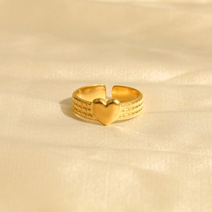 Minimalist gold heart open ring with woven texture finish on a silk background