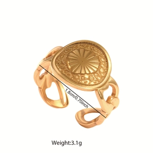 Detailed view of adjustable gold-tone sunburst ring with 1.8cm diameter and hollow band