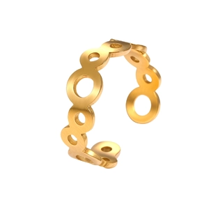 Detailed macro view of gold-plated open ring featuring a rhythmic hollow circle design