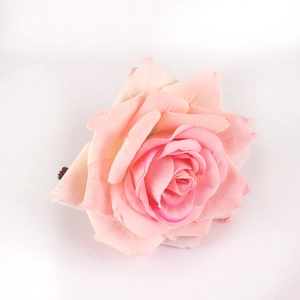 Macro shot of handmade pink fabric rose napkin ring with layered silk petals and details