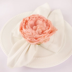 Elegant napkin ring featuring a large soft pink peony flower on a white ceramic dinner plate