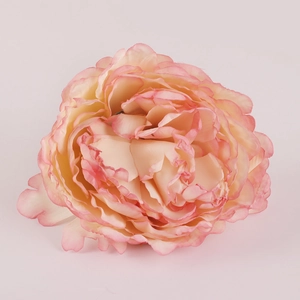 Macro detail of artificial pink peony napkin ring showing soft silk fabric petals