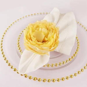 Elegant table setting with handmade yellow peony napkin ring and white lace fabric napkin