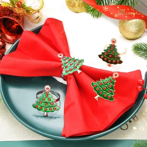 Detail view of 4-piece green enamel Christmas tree napkin rings with red rhinestones