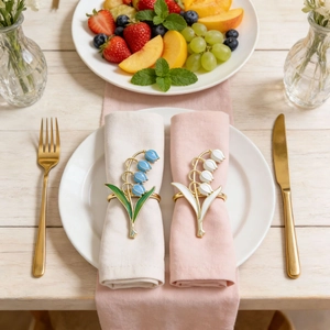 Detailed view of lily of the valley napkin rings with blue and white enamel flowers