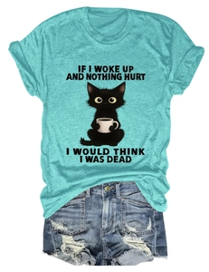 Flat lay of women's teal t-shirt with funny cat print and distressed denim shorts