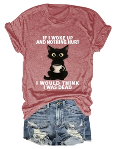 Flat lay of a funny cat print t-shirt paired with distressed denim shorts
