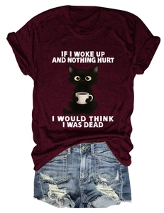 Flat lay of burgundy cotton T-shirt with cat graphic and denim shorts set