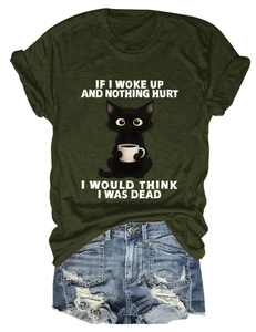 Flat lay of army green crew neck tee with cat graphic and distressed denim shorts