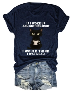 Detail view of navy cotton T-shirt featuring cartoon cat print and blue denim shorts