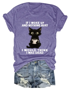 Detail of purple cotton T-shirt featuring a funny black cat print and denim shorts