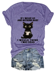 Detail of purple cotton T-shirt featuring a funny cat graphic and distressed denim shorts