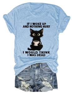 Detail of light blue t-shirt with cartoon cat print and distressed denim shorts set