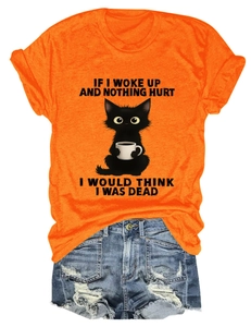 Close-up of bright orange crew neck T-shirt with funny black cat and coffee print