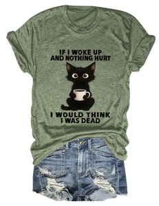 Detail of olive green t-shirt with funny cat print and distressed denim shorts