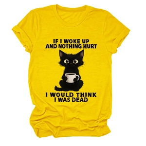 Detailed flat lay of a yellow cotton T-shirt featuring a cute black cat with a coffee mug