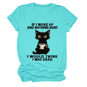 Detail of teal t-shirt featuring a cartoon cat with humor quote and coffee cup