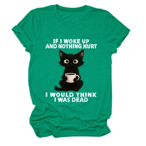 Detail of green cotton T-shirt featuring funny black cat drinking coffee and white text graphic