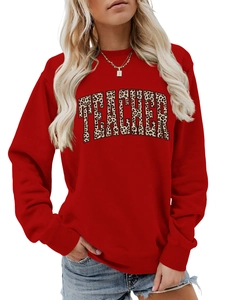 Detail of red sweatshirt showing TEACHER leopard print text and ribbed cuffs