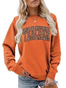 Detailed view of the leopard print Teacher lettering on the orange sweatshirt