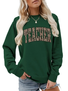 Detail of dark green teacher sweatshirt with leopard print letters and ribbed cuffs