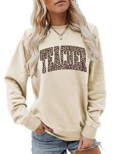 Detail of Teacher leopard print lettering on a cream crewneck long sleeve sweatshirt