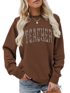 Detail of Teacher letter print with leopard pattern on brown crewneck sweatshirt