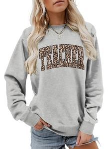 Close-up of leopard print TEACHER lettering on a grey crewneck sweatshirt for women