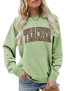 Detail of the leopard print 'TEACHER' lettering on a mint green long sleeve sweatshirt