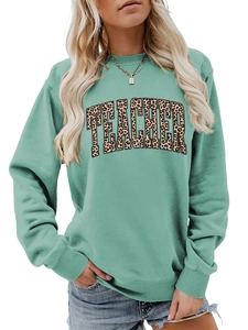 Detail view of mint green sweatshirt featuring leopard print TEACHER text and crew neck