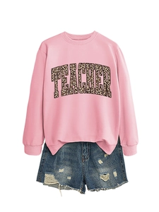 Pink sweatshirt with leopard print teacher slogan paired with distressed denim shorts