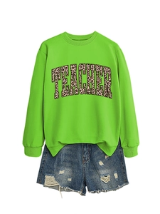Macro detail of leopard print Teacher lettering on a neon green sweatshirt fabric